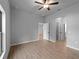 Spacious bedroom featuring neutral walls, tile floors, a ceiling fan, and multiple doorways at 3376 Dunbar St, Port Charlotte, FL 33948