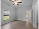 Bedroom features wood-look tile flooring, ceiling fan and ample natural light from the window at 3376 Dunbar St, Port Charlotte, FL 33948