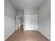 Bright bedroom features light gray walls, wood-look tile floors, closet, and open doorway to the hallway at 3376 Dunbar St, Port Charlotte, FL 33948