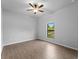 Bright, neutral bedroom with wood-look tile floors and view of the backyard at 3376 Dunbar St, Port Charlotte, FL 33948