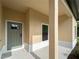 Front entrance featuring neutral stucco, a gray-trimmed door, and a window for natural light at 3376 Dunbar St, Port Charlotte, FL 33948