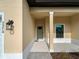 Charming front entrance with a classic black lantern, walkway, and garden view window at 3376 Dunbar St, Port Charlotte, FL 33948