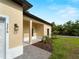 Inviting home exterior with a covered entry and manicured landscaping, set against a bright blue sky at 3376 Dunbar St, Port Charlotte, FL 33948