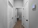 Hallway with neutral walls, a thermostat, and several white doors leading to various rooms at 3376 Dunbar St, Port Charlotte, FL 33948