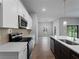 Modern kitchen showcasing white cabinets, stainless steel appliances, and a kitchen island with a sink at 3376 Dunbar St, Port Charlotte, FL 33948