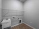 Functional laundry room with a utility sink, shelving, and washer/dryer hookups for convenience at 3376 Dunbar St, Port Charlotte, FL 33948