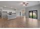 Open-concept living room and kitchen with wood tile flooring and sliding glass doors to the backyard at 3376 Dunbar St, Port Charlotte, FL 33948