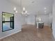 Open concept living space with modern chandelier over dining area and kitchen island at 3376 Dunbar St, Port Charlotte, FL 33948
