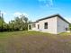 View of the home's backyard and covered patio, perfect for relaxing or entertaining at 4081 Felhorn St, Port Charlotte, FL 33948