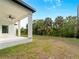 Enjoy outdoor living on this covered back porch, perfect for relaxing and overlooking the spacious backyard at 4081 Felhorn St, Port Charlotte, FL 33948