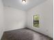 Simple bedroom with wood-look tile floors and a window providing natural light at 4081 Felhorn St, Port Charlotte, FL 33948