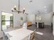 Open-concept dining room with contemporary lighting and access to living room at 4081 Felhorn St, Port Charlotte, FL 33948