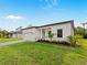 Beautiful home with a modern exterior, attached garage, paver driveway, and lush landscaping at 4081 Felhorn St, Port Charlotte, FL 33948