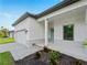 Charming home featuring a modern exterior, paver driveway, attached garage, and manicured landscaping at 4081 Felhorn St, Port Charlotte, FL 33948