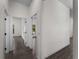 Hallway with neutral walls and dark flooring at 4081 Felhorn St, Port Charlotte, FL 33948