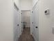 Hallway with modern tile floors, doors and leading to a laundry area at 4081 Felhorn St, Port Charlotte, FL 33948
