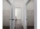 Hallway featuring closet doors with hardware, and bathroom at the end of the hall at 4081 Felhorn St, Port Charlotte, FL 33948