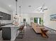 Open-concept kitchen and living room with pendant lighting, breakfast bar seating, and stylish decor at 4081 Felhorn St, Port Charlotte, FL 33948