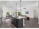 Bright and airy open floorplan featuring a kitchen island, dining area, and living room at 4081 Felhorn St, Port Charlotte, FL 33948