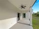 View of the home's covered patio, with a ceiling fan and sliding glass doors that provide indoor-outdoor living at 4081 Felhorn St, Port Charlotte, FL 33948
