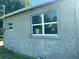 Side view of a house with newly installed windows and stucco walls at 612 Milus St, Punta Gorda, FL 33950