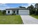 Modern single-story home with a gray paver driveway at 173 Edgemere Nw St, Port Charlotte, FL 33948