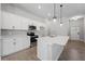 Modern kitchen with white cabinets and island at 173 Edgemere Nw St, Port Charlotte, FL 33948