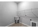 Laundry room with shelving, utility sink, and tile flooring at 173 Edgemere Nw St, Port Charlotte, FL 33948