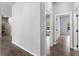 Bright hallway with tile flooring and doors leading to bedrooms at 173 Edgemere Nw St, Port Charlotte, FL 33948