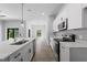 Modern kitchen with white cabinets, stainless steel appliances, and quartz countertops at 173 Edgemere Nw St, Port Charlotte, FL 33948