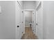 Clean hallway with white doors leading to laundry and other rooms at 173 Edgemere Nw St, Port Charlotte, FL 33948