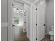 Hallway with tile flooring and doors to bathroom and bedroom at 173 Edgemere Nw St, Port Charlotte, FL 33948
