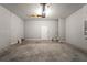 Unfinished garage with concrete floor and overhead door at 173 Edgemere Nw St, Port Charlotte, FL 33948