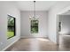Sunlit dining room with large windows and tile floors at 173 Edgemere Nw St, Port Charlotte, FL 33948