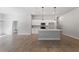 Open-concept kitchen with white cabinets and island at 173 Edgemere Nw St, Port Charlotte, FL 33948