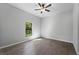 Well-lit bedroom with tile floor and a large window overlooking backyard at 173 Edgemere Nw St, Port Charlotte, FL 33948