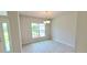 Bright dining room with tile floors and a chandelier, featuring a view of the backyard at 2536 Jacobs St, Port Charlotte, FL 33953