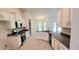 Modern kitchen with white cabinets, granite countertops, and stainless steel appliances at 2536 Jacobs St, Port Charlotte, FL 33953