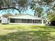 Spacious backyard featuring a screened in back porch with a shed on the side of the house at 5731 Oakview Ln, Punta Gorda, FL 33950