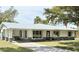 Charming single-story home with modern windows, stone accents, and a well-manicured lawn at 5731 Oakview Ln, Punta Gorda, FL 33950