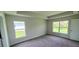 Bright bedroom with two windows and neutral carpeting at 2552 Jacobs St, Port Charlotte, FL 33953