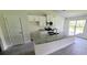 Kitchen with white cabinets, granite island and stainless steel appliances at 2552 Jacobs St, Port Charlotte, FL 33953