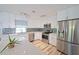 Modern kitchen with white cabinets, stainless steel appliances, and quartz countertops at 5731 Oakview Ln, Punta Gorda, FL 33950