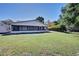Rear view of a single story house with a large screened in porch at 5731 Oakview Ln, Punta Gorda, FL 33950