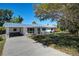 Ranch-style home with metal roof and stone accents at 5731 Oakview Ln, Punta Gorda, FL 33950