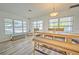 Charming dining area with a wood table, bench seating, and large windows at 5731 Oakview Ln, Punta Gorda, FL 33950