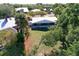 Aerial view of the house and backyard, showcasing the screened porch and landscaping at 5731 Oakview Ln, Punta Gorda, FL 33950