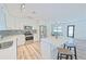 Modern kitchen with white cabinets, stainless steel appliances, and a large island at 5731 Oakview Ln, Punta Gorda, FL 33950