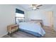 Bright bedroom with a bed, nightstand and wood-look floors at 5731 Oakview Ln, Punta Gorda, FL 33950