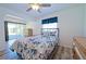 Bedroom with floral bedding, wood dresser, and access to a screened porch at 5731 Oakview Ln, Punta Gorda, FL 33950